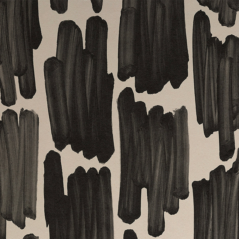 Detail of wallpaper in an abstract paint swatch print in black on a cream field.