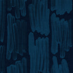 Detail of wallpaper in an abstract paint swatch print in blue on a black field.