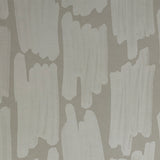 Detail of wallpaper in an abstract paint swatch print in light gray on a gray field.