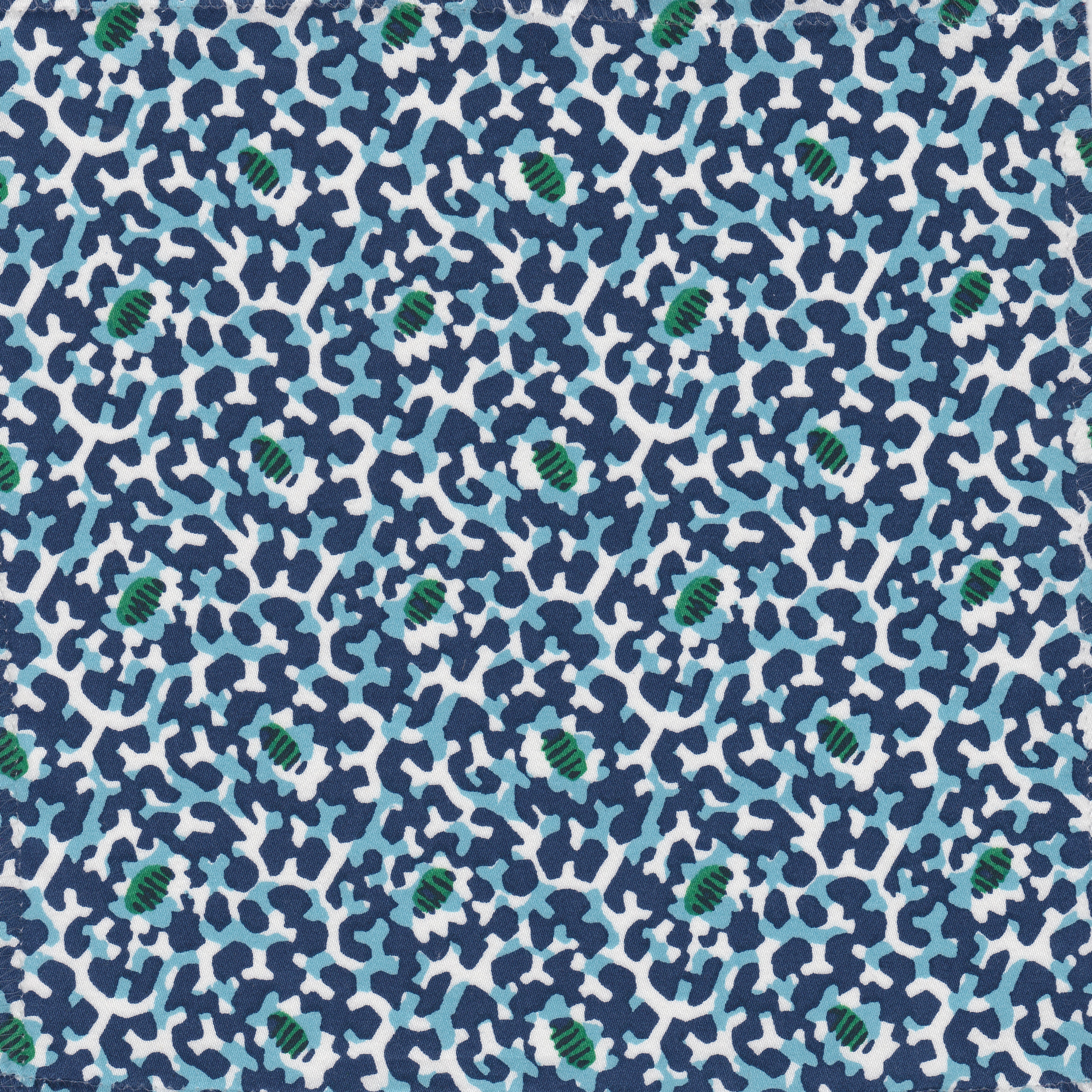 Detail of fabric in a playful irregular botanical print in green, blue and navy on a white field.