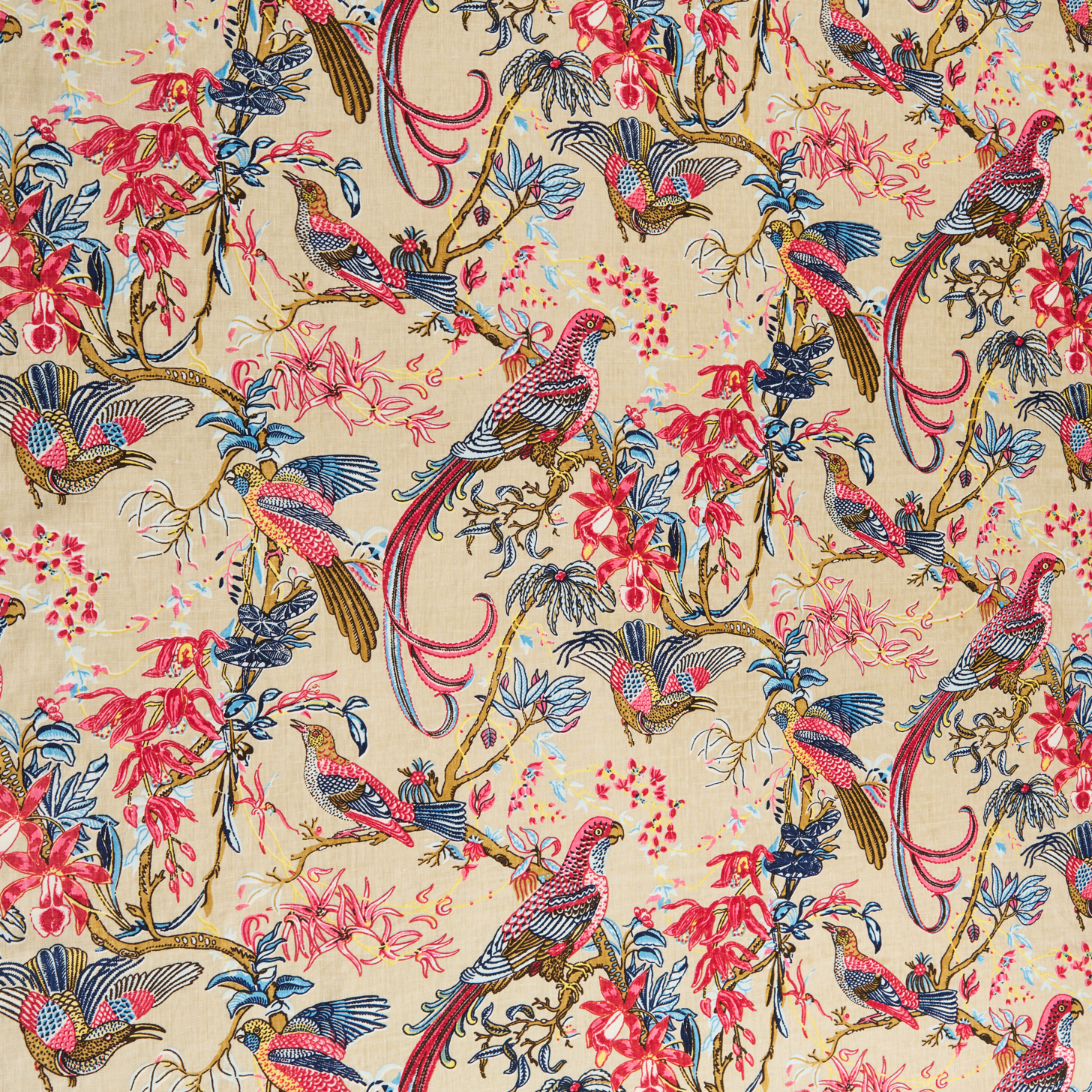 Printed fabric in a lyrical jungle design with tropical birds and leafy branches in pink, tan, blue and yellow on a beige field.