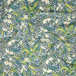 Draped fabric in a dense floral print in yellow, green and navy on a cream field.
