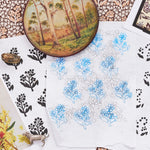 Collection of floral and nature-themed sketches on a floral patterned fabric