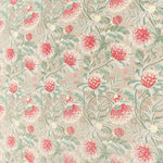 Printed fabric in a lush floral botanical design in red, pink, yellow green and turquoise on a tan field. 