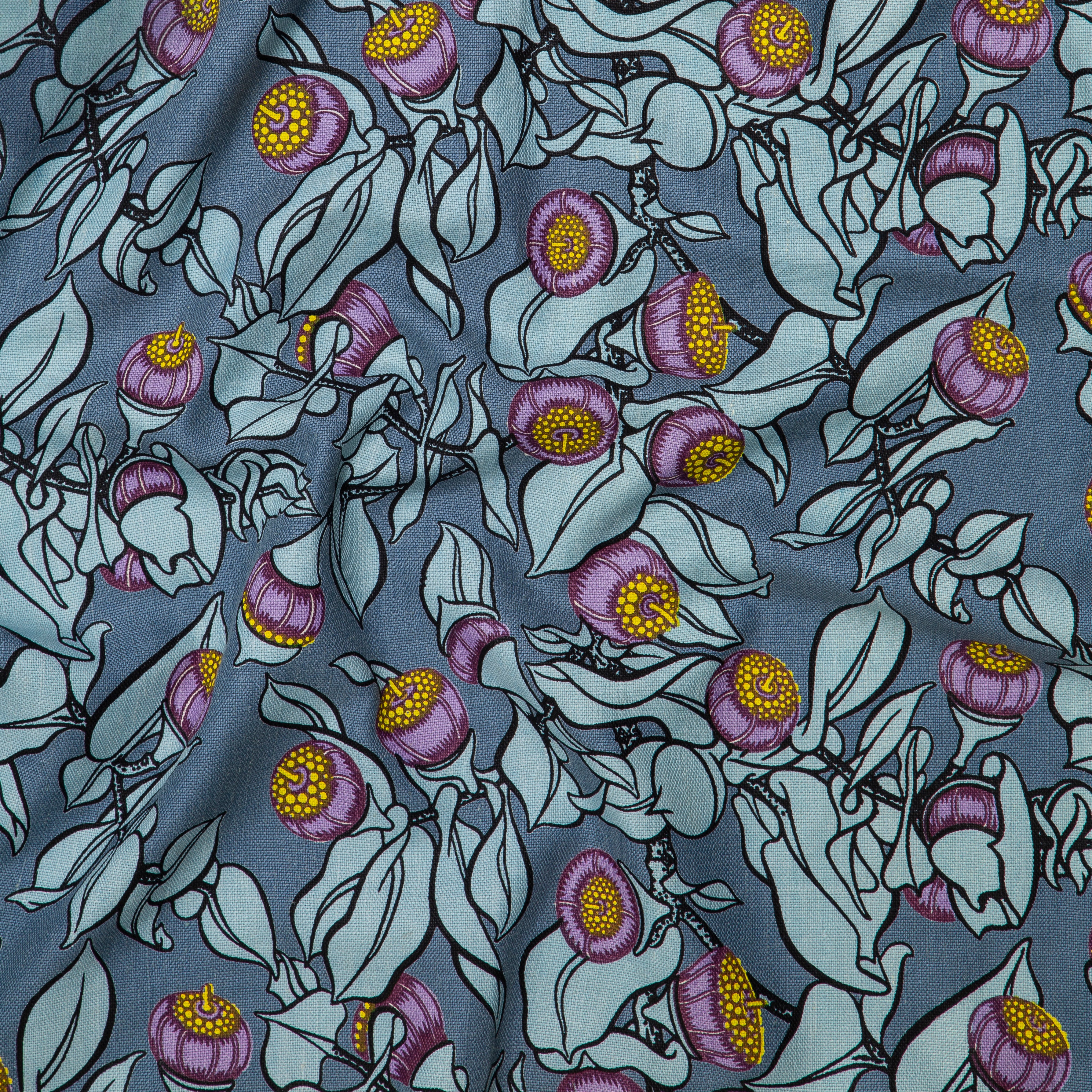 Draped fabric in a leaf and bud print in shades of blue, purple and yellow on a navy field.