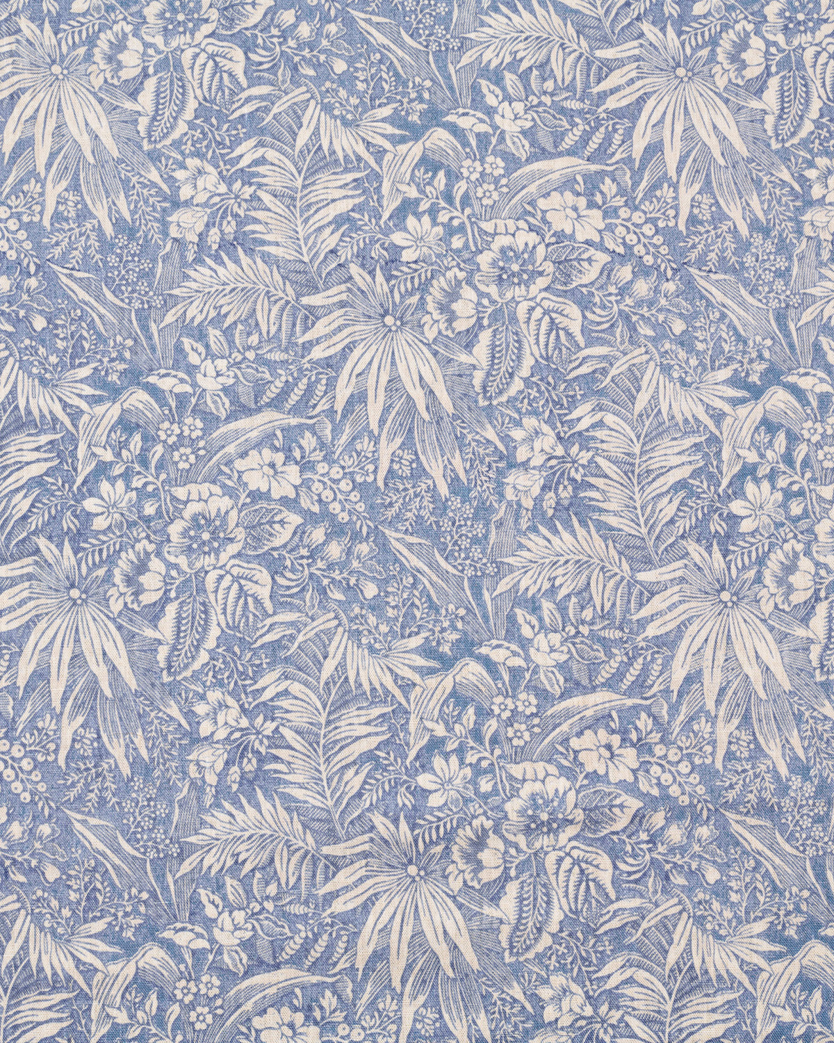 Floral and leaf pattern in blue and white on a blue background