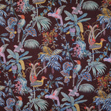 Detail of fabric in a dense leaf and bird print in a rainbow of shades on a dark brown field.