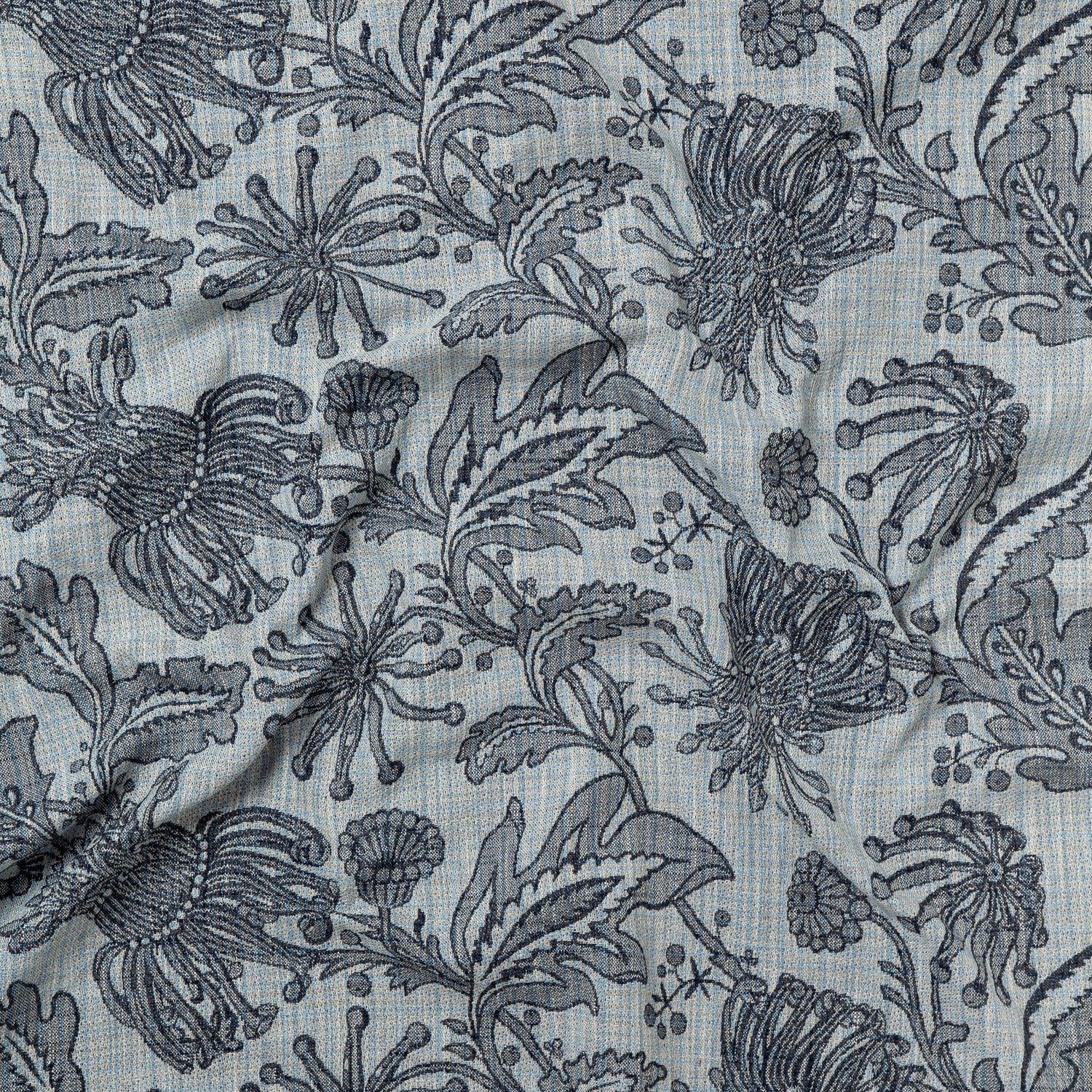 Draped fabric yardage in a large-scale floral print in gray on a light gray field.