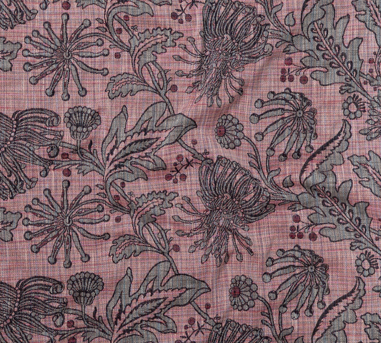 Draped fabric yardage in a large-scale floral print in gray and red on a pink field.