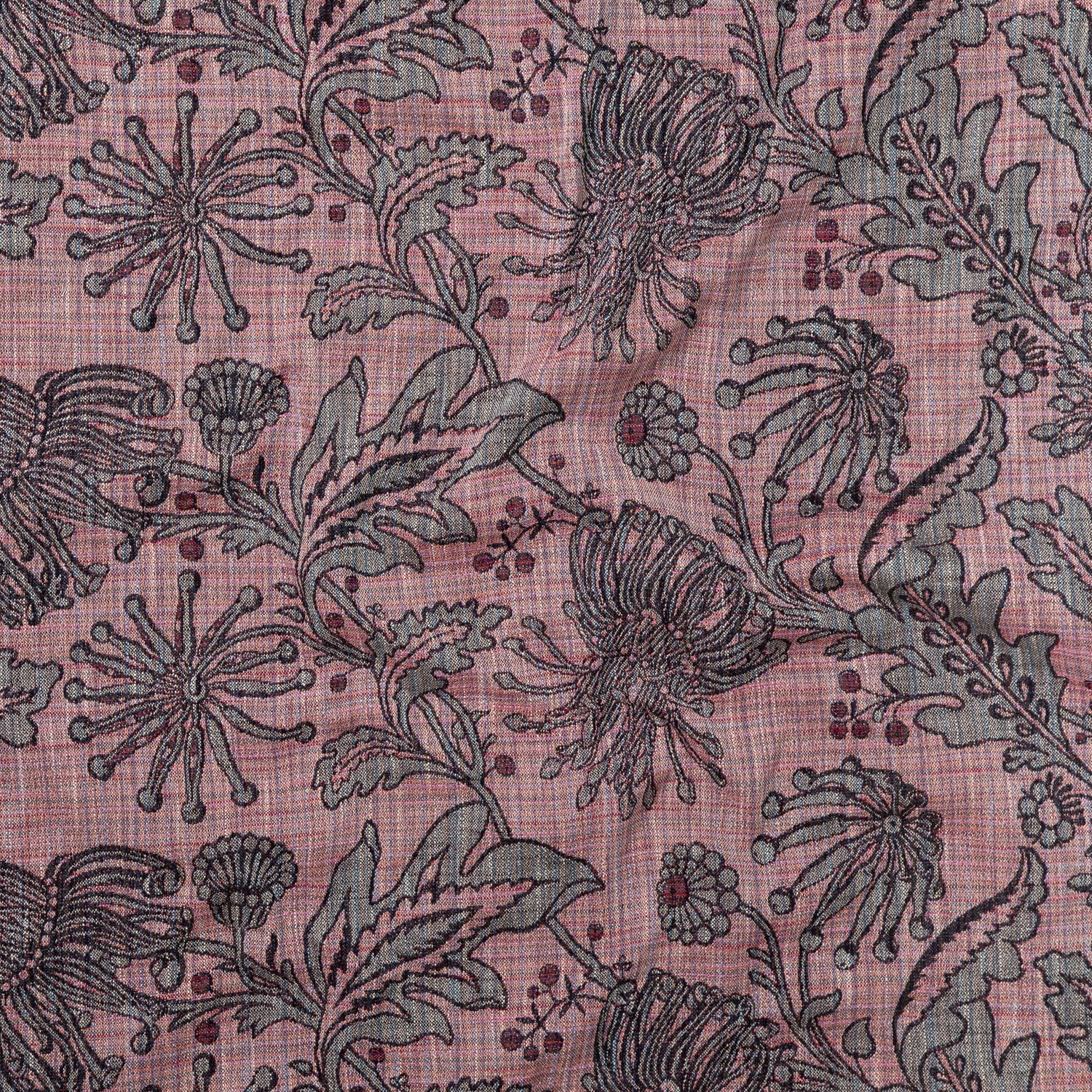 Draped fabric yardage in a large-scale floral print in gray and red on a pink field.