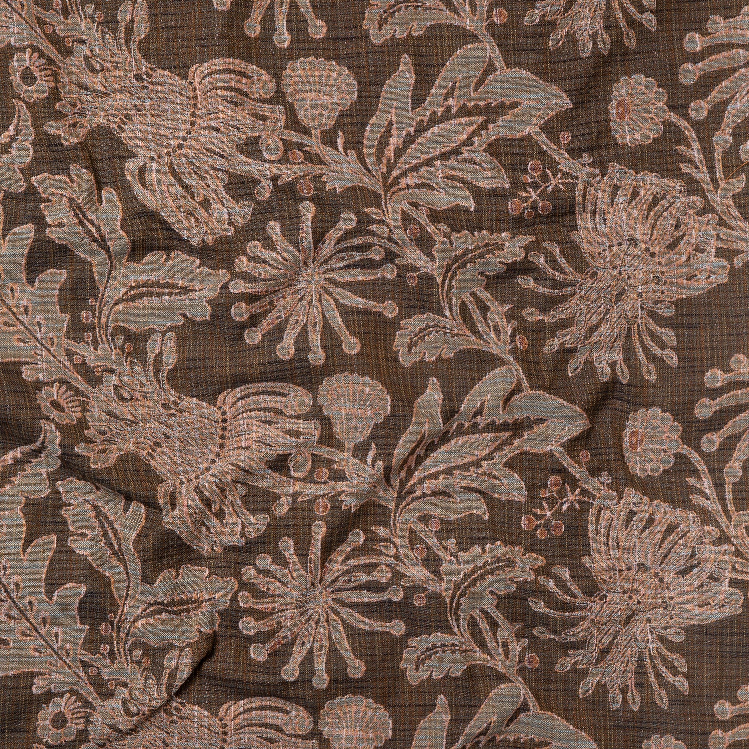 Draped fabric yardage in a large-scale floral print in gray and pink on a brown field.