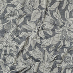 Draped fabric in a leaf and bud print in gray on a dark gray field.