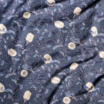 Draped fabric in a floral print in shades of navy and tan on a navy field.