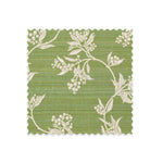 Fabric swatch on white of performance fabric with a scrolling floral design in green. 