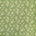 Performance fabric with a scrolling floral design in green. 