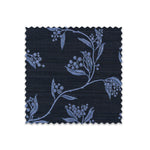 Fabric swatch on white of performance fabric with a scrolling floral design in navy blue.