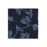 Fabric swatch on white of performance fabric with a scrolling floral design in navy blue.
