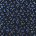 Performance fabric with a scrolling floral design in navy blue. 