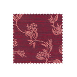 Fabric swatch on white of performance fabric with a scrolling floral design in magenta pink.