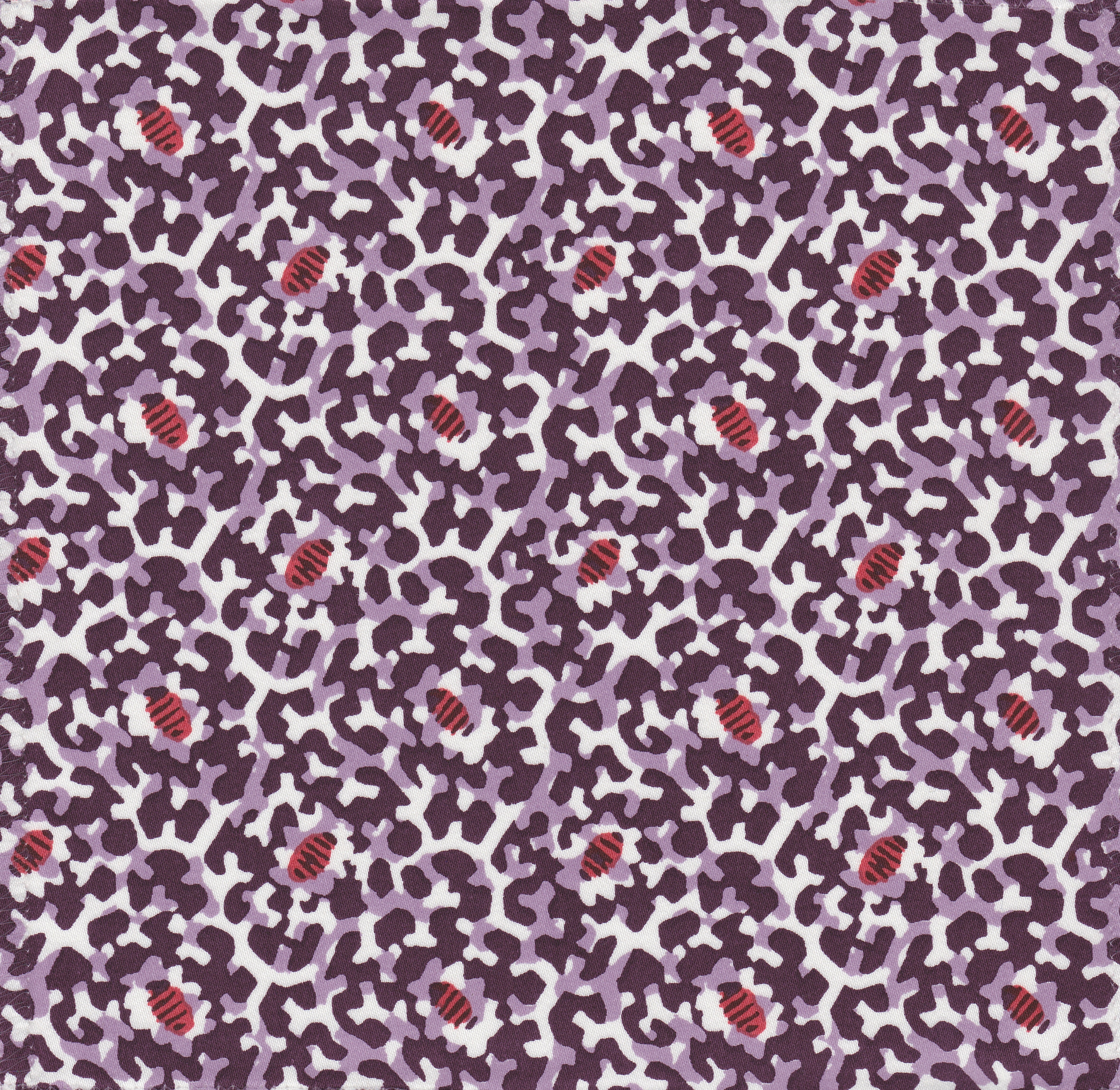 Detail of fabric in a playful irregular botanical print in red and purple on a white field.