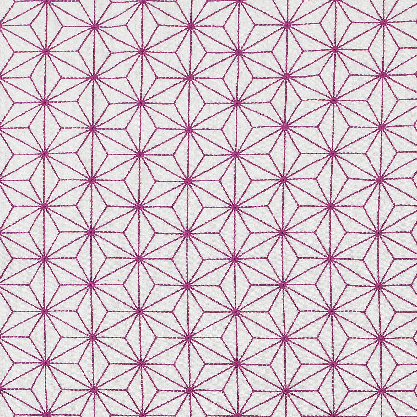 Fabric with an embroidered floral lattice print in maroon on a cream field.