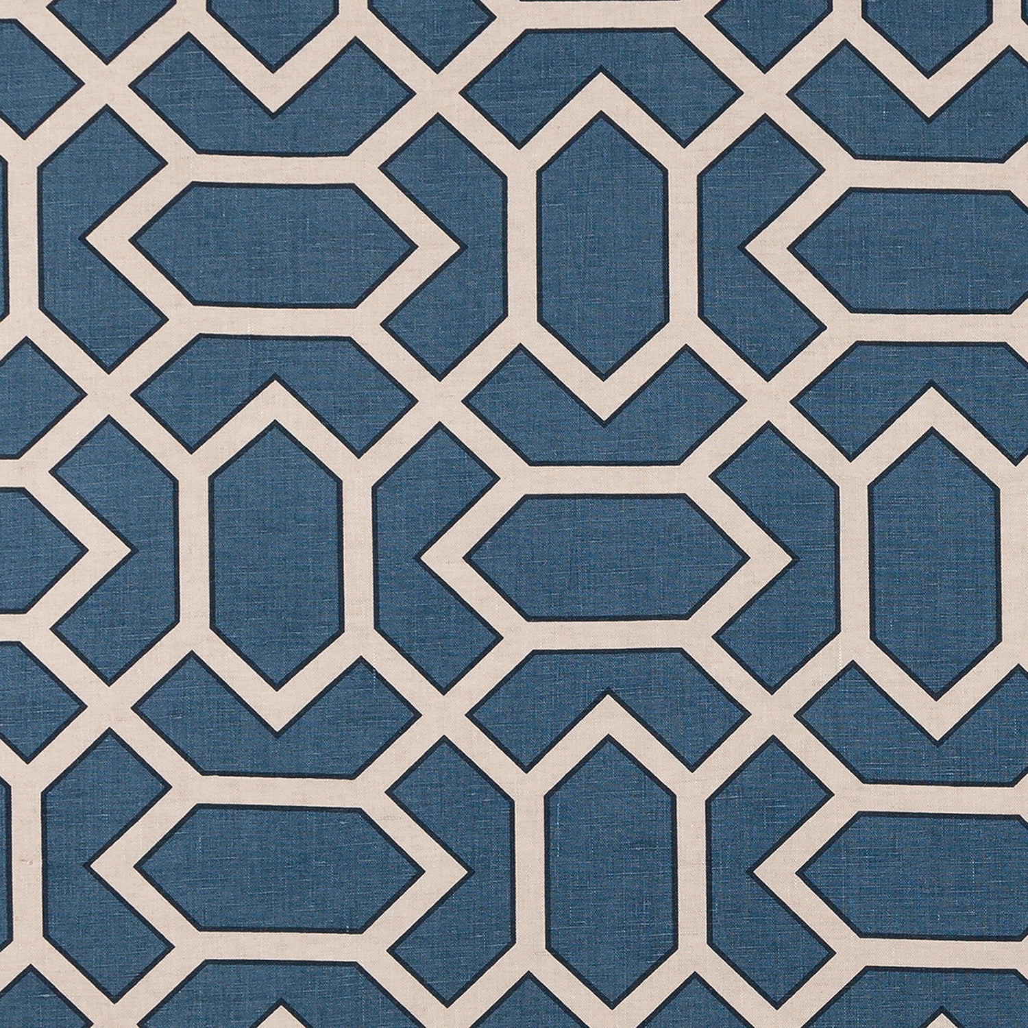 Fabric in a geometric lattice print in cream and black on a navy field.