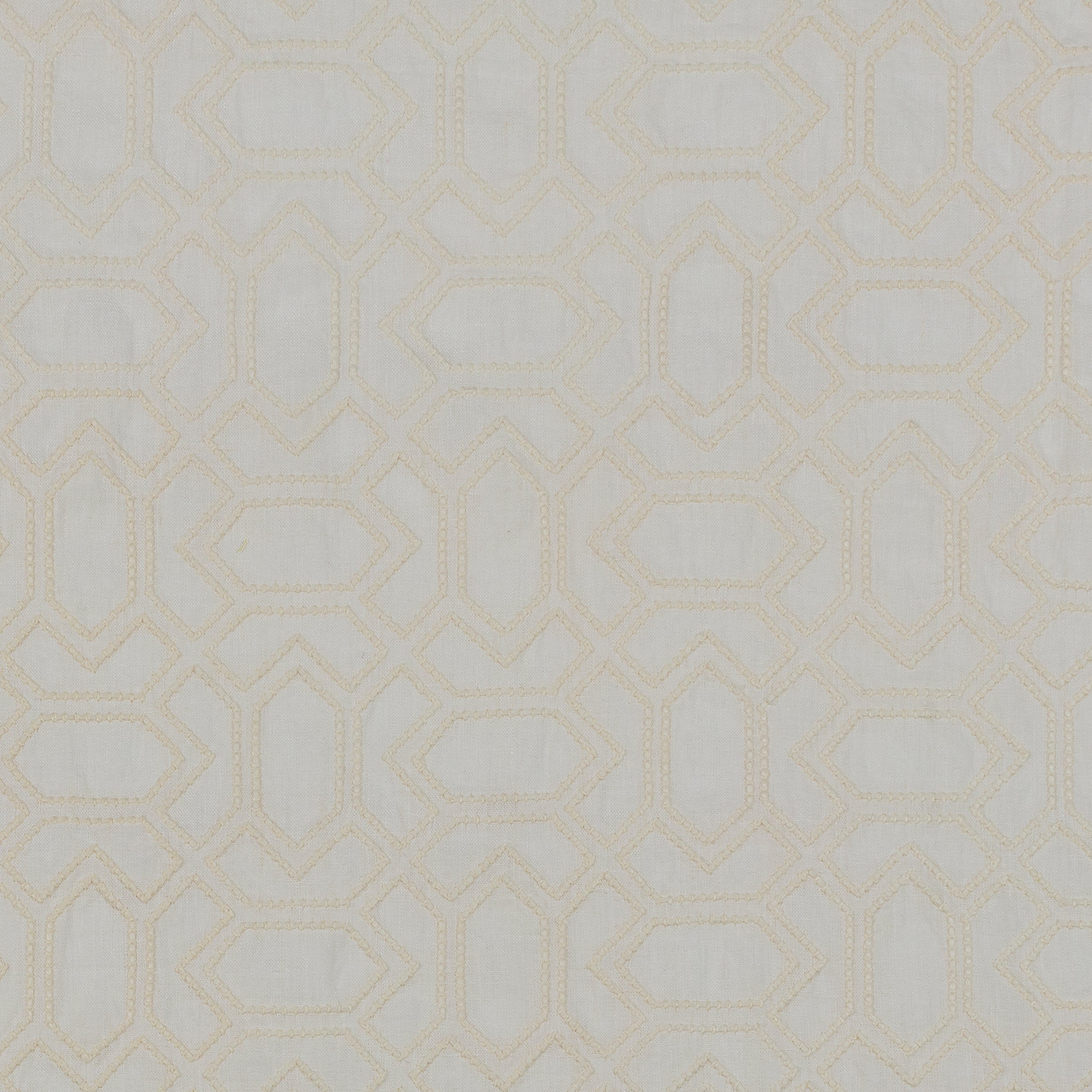 Fabric with an embroidered geometric grid print in cream on a light gray field.