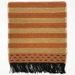 Striped rug with brown and coral  with black fringe on a white background
