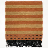 Striped rug with brown and coral  with black fringe on a white background