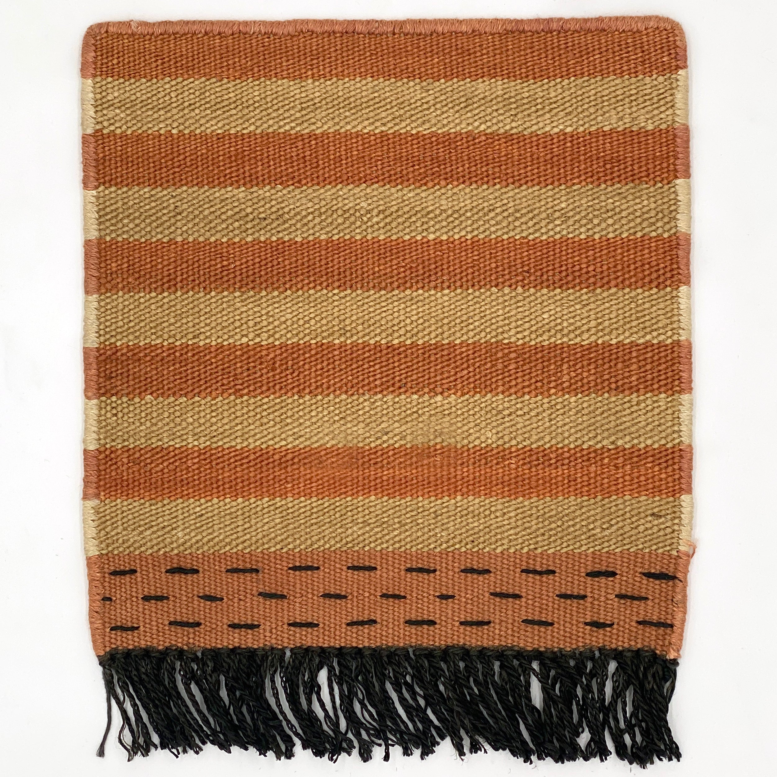 Striped rug with brown and coral  with black fringe on a white background