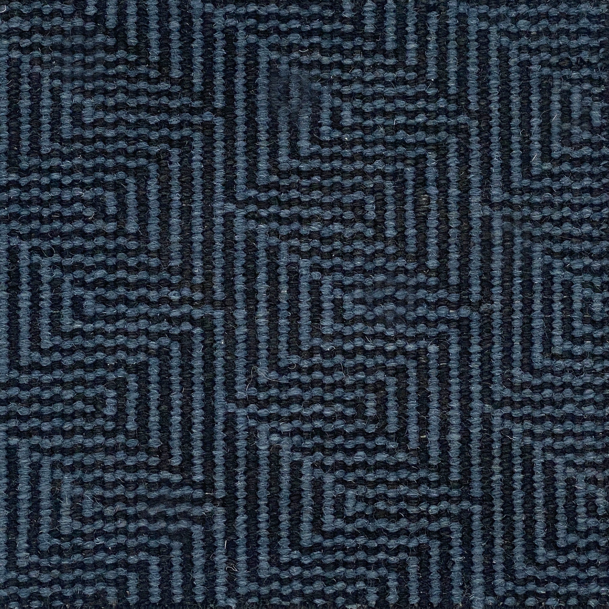 Patterned carpet with a zigzag design in black and blue.
