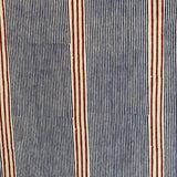 Detail of fabric in an irregular stripe print in navy and rust on a cream field.