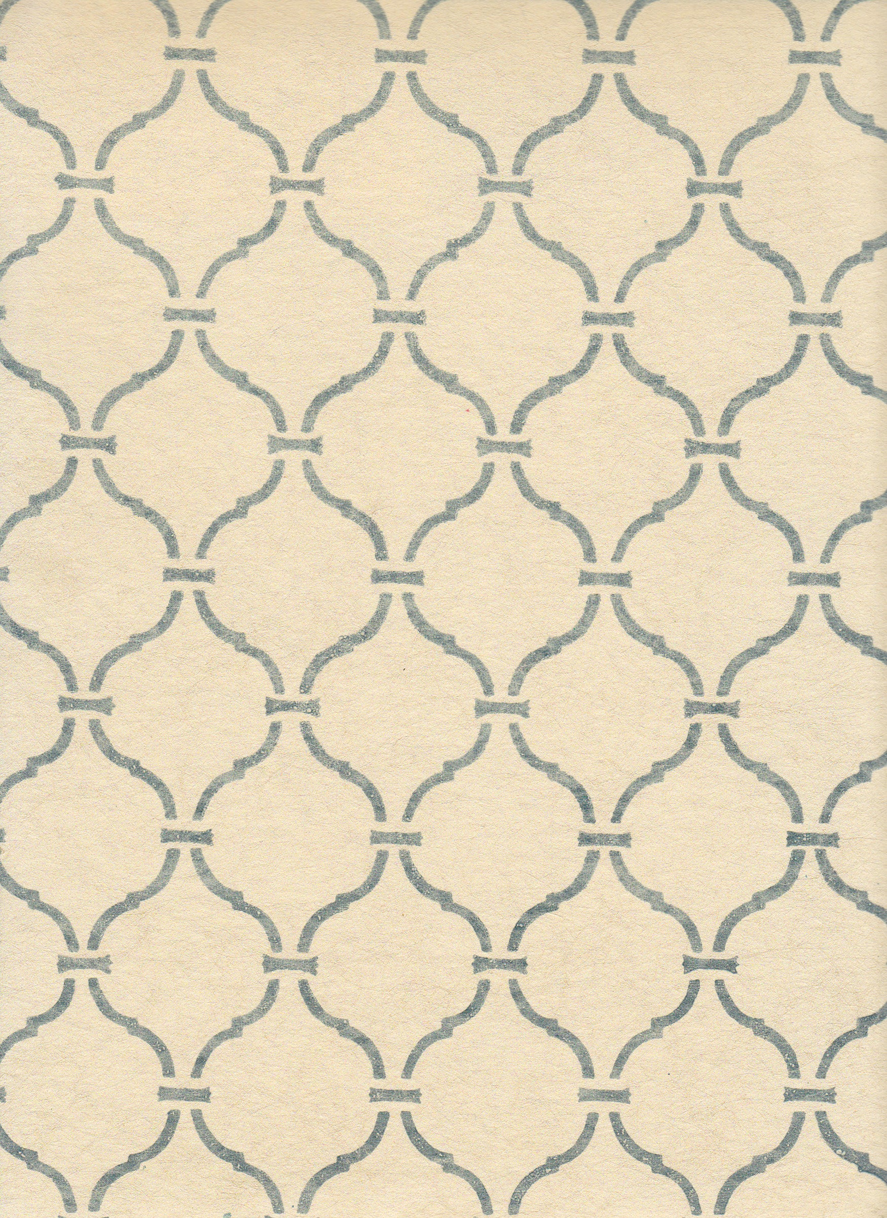 Detail of wallpaper in a curvilinear lattice print in blue-gray on a cream field.