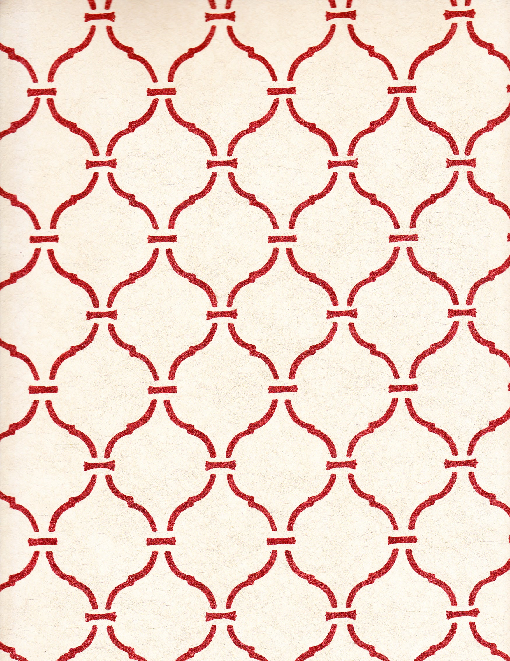 Detail of wallpaper in a curvilinear lattice print in red on a cream field.