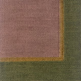 Close up of a flatweave rug in light purple with tan and green border. 