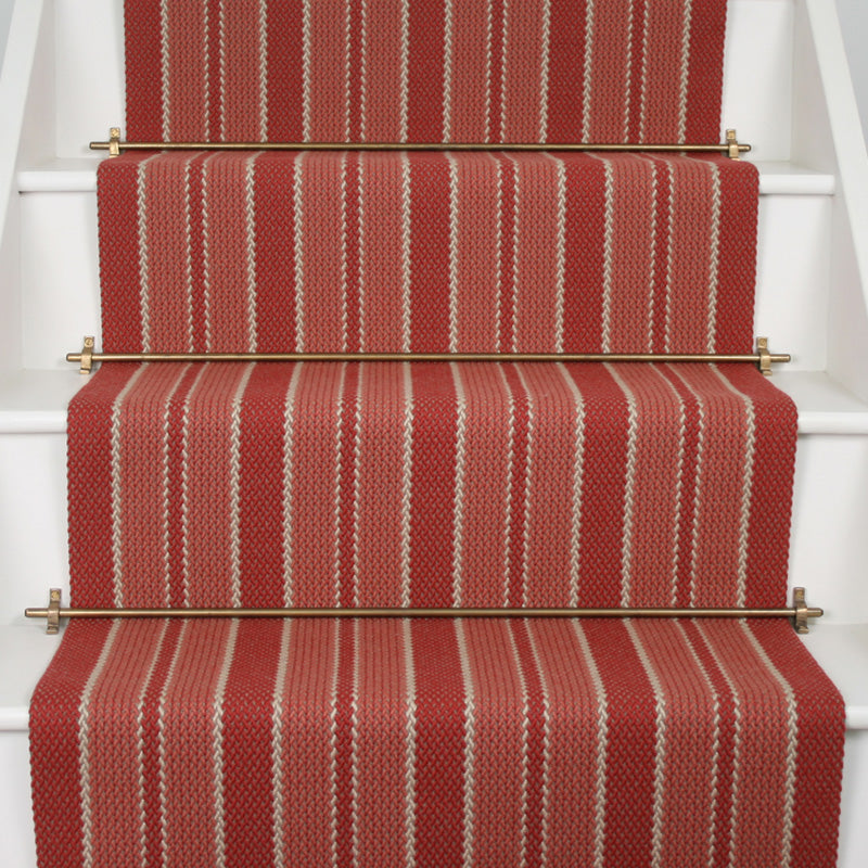 Striped flatweave runner in red and pink on white staircase