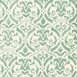 Detail of fabric in a botanical damask print in turquoise on a cream field.