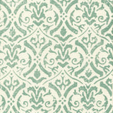 Detail of fabric in a botanical damask print in turquoise on a cream field.