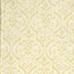 Detail of fabric in a botanical damask print in tan on a cream field.