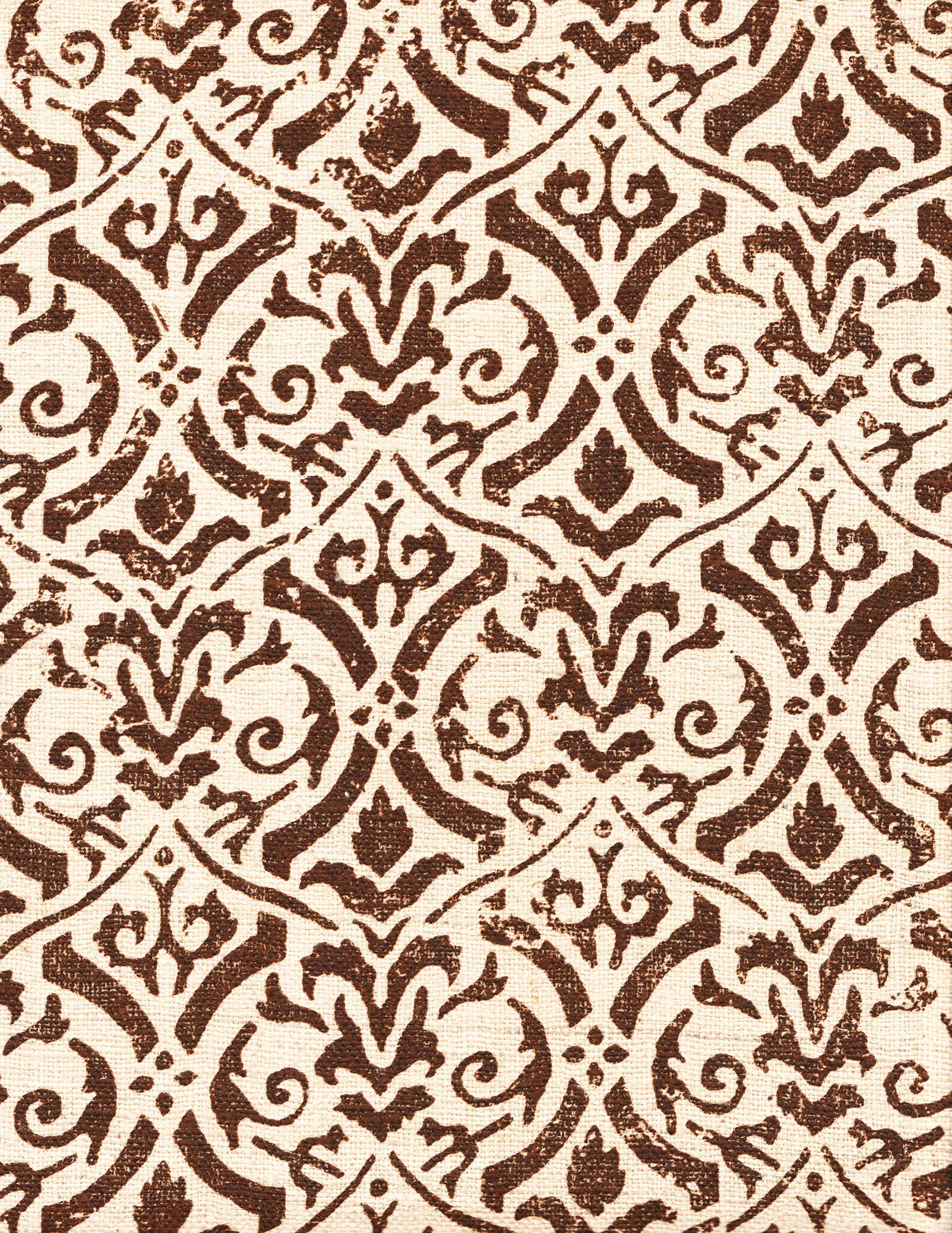 Detail of fabric in a botanical damask print in dark brown on a cream field.