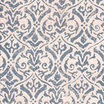 Detail of fabric in a botanical damask print in blue-gray on a cream field.