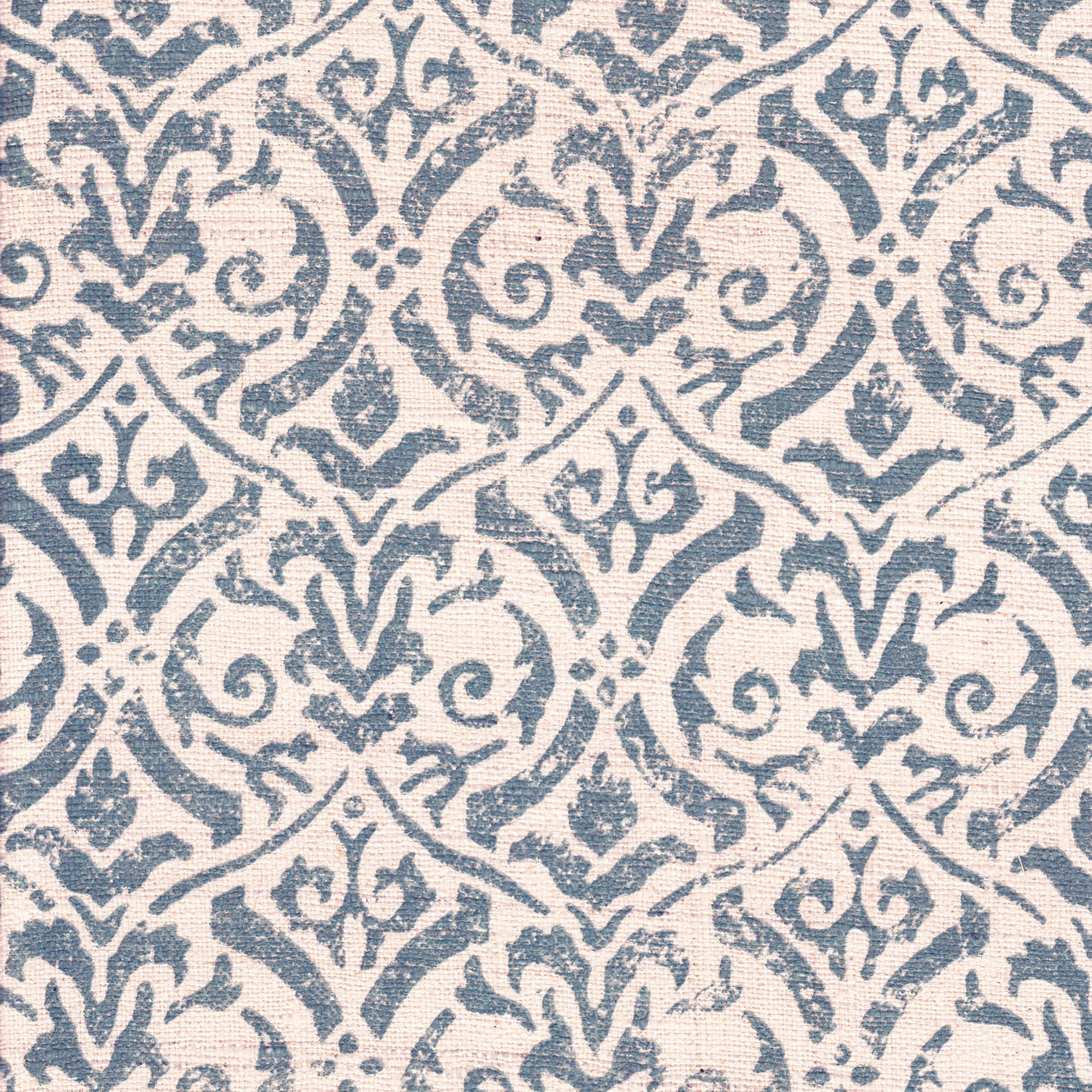 Detail of fabric in a botanical damask print in blue-gray on a cream field.