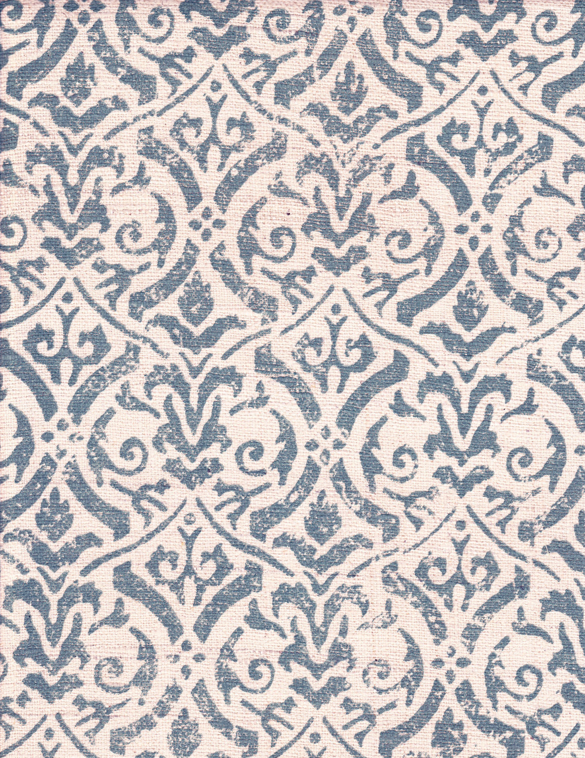 Detail of fabric in a botanical damask print in blue-gray on a cream field.