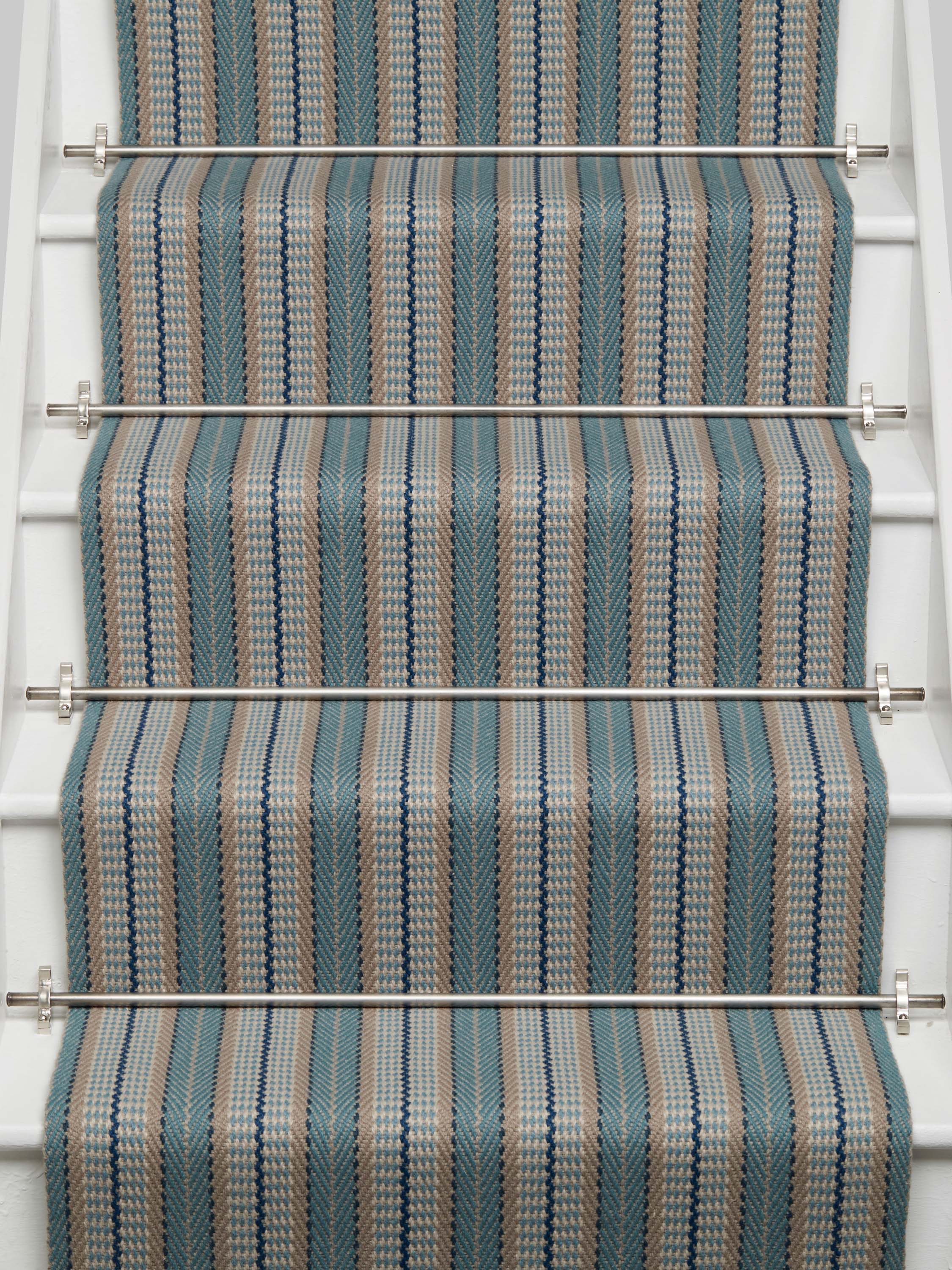 Striped flatweave runner in tan and blue on white staircase