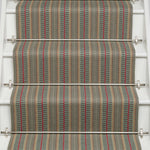 Striped flatweave runner in tan red and blue on white staircase