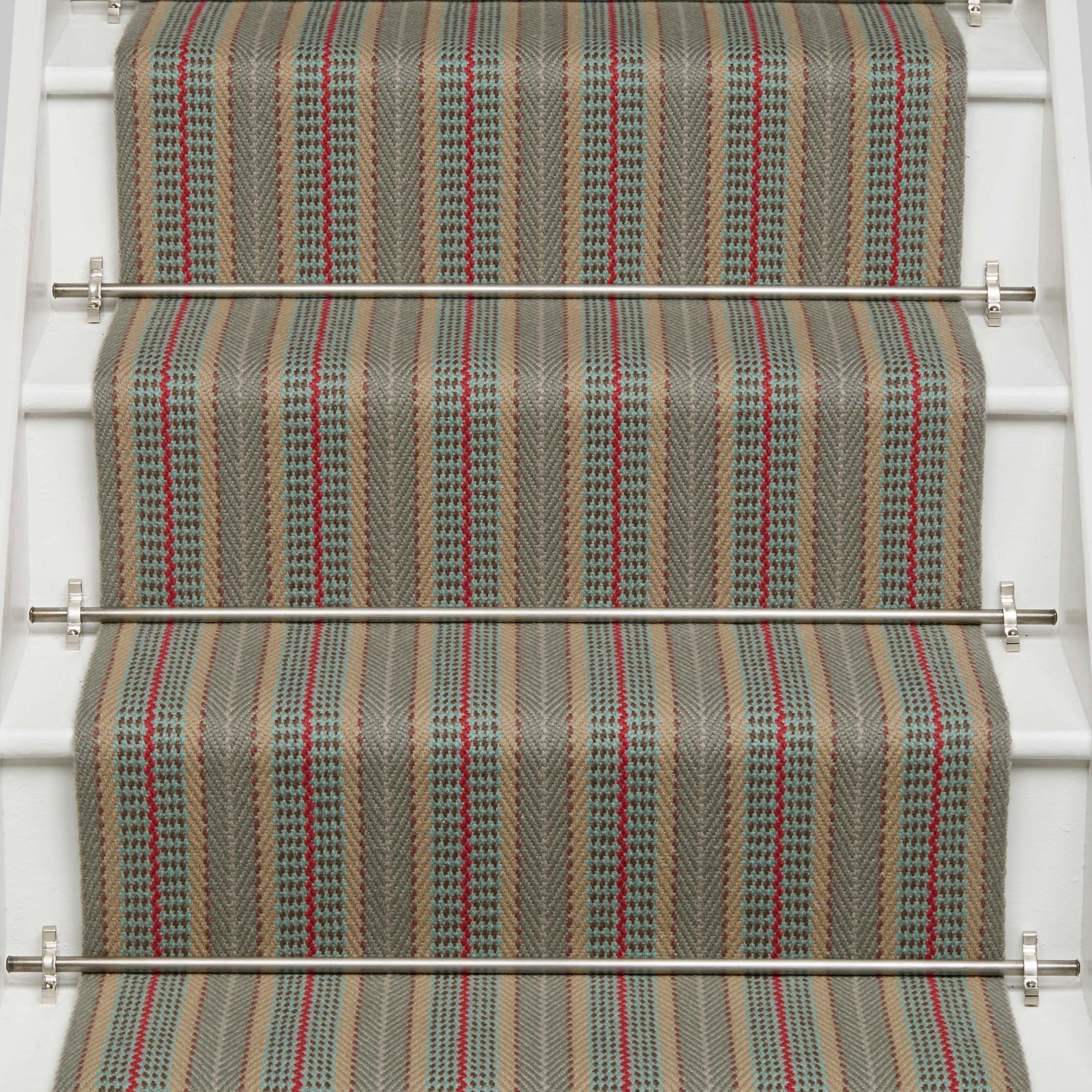 Striped flatweave runner in tan red and blue on white staircase