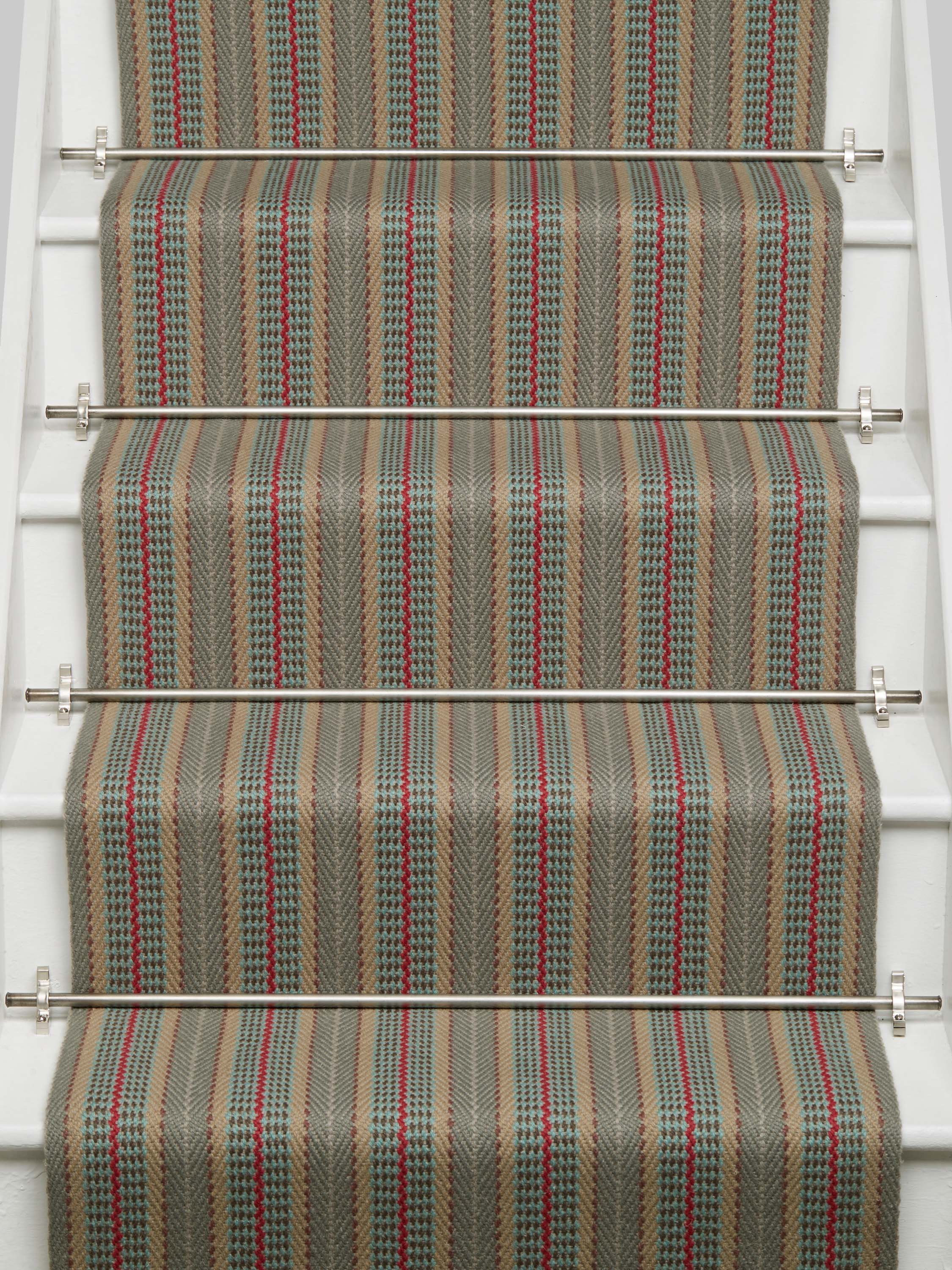 Striped flatweave runner in tan red and blue on white staircase