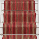 Striped flatweave runner in red and tan on white staircase