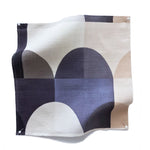 Square fabric swatch in a curvy geometric print in shades of white, cream, gray and charcoal.