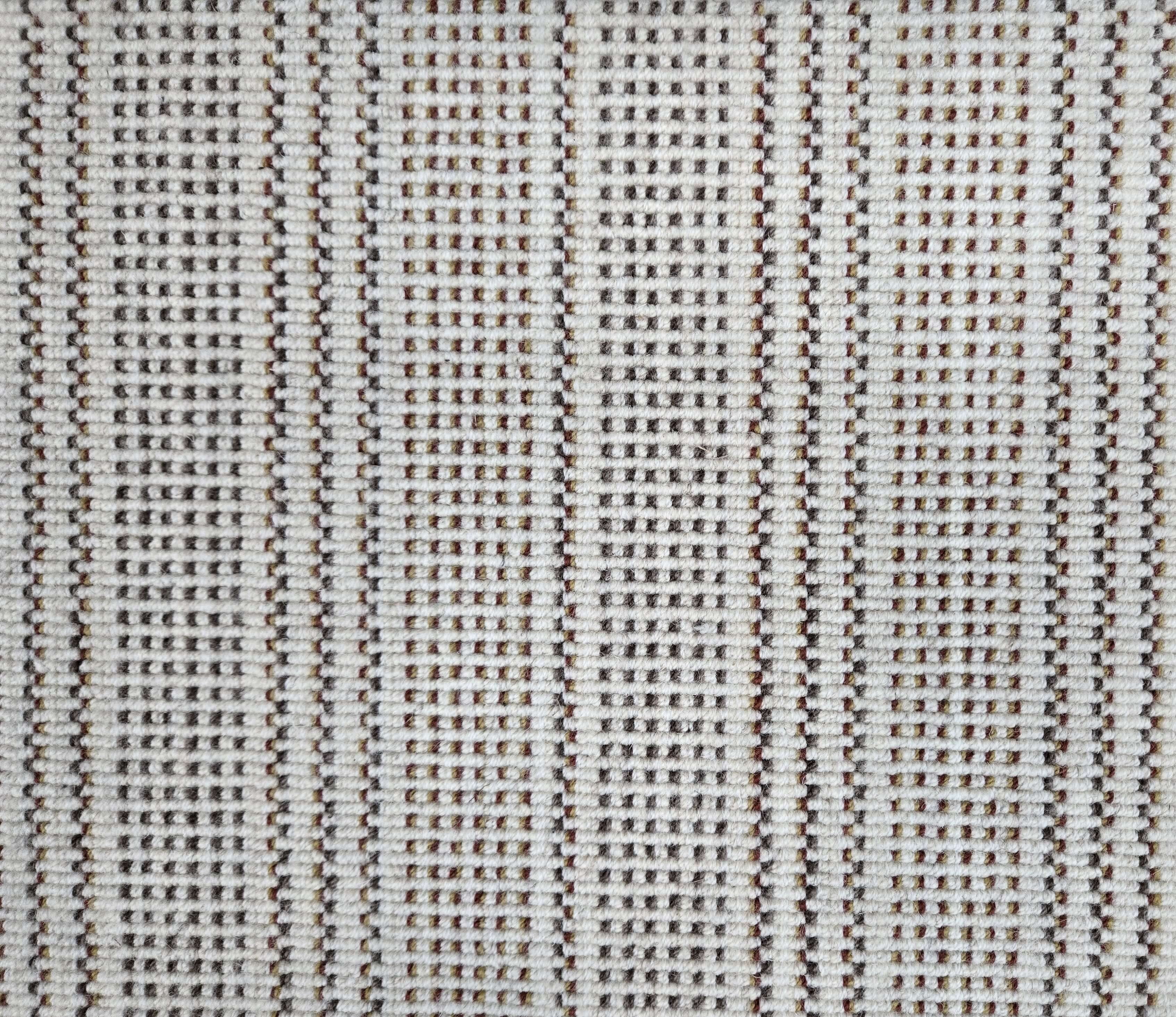 Broadloom carpet in dashed stripe pattern in shades of brown with cream. 